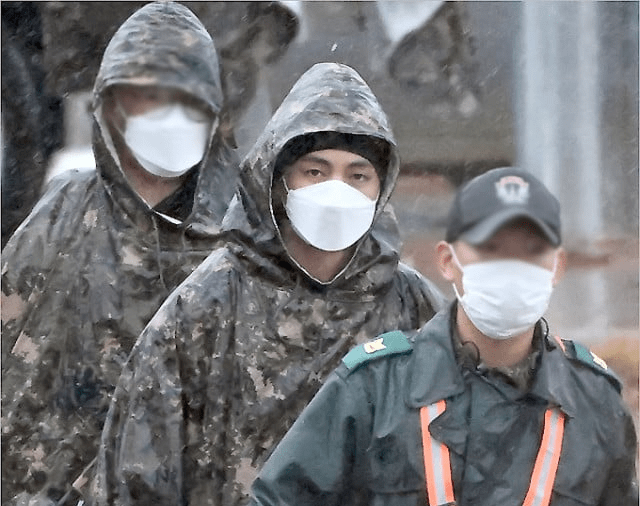Amidst Raindrops and Honor: BTS V and RM's Debut in Military Attire Captured in Striking Photographs